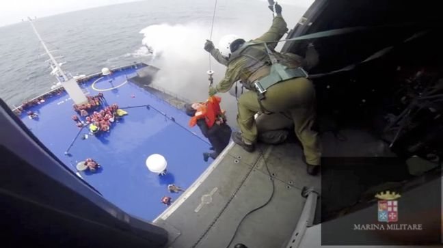 Handout video grab showing a person being lifted on an Italian Navy helicopter as the car ferry Norman Atlantic burns in waters off Greece