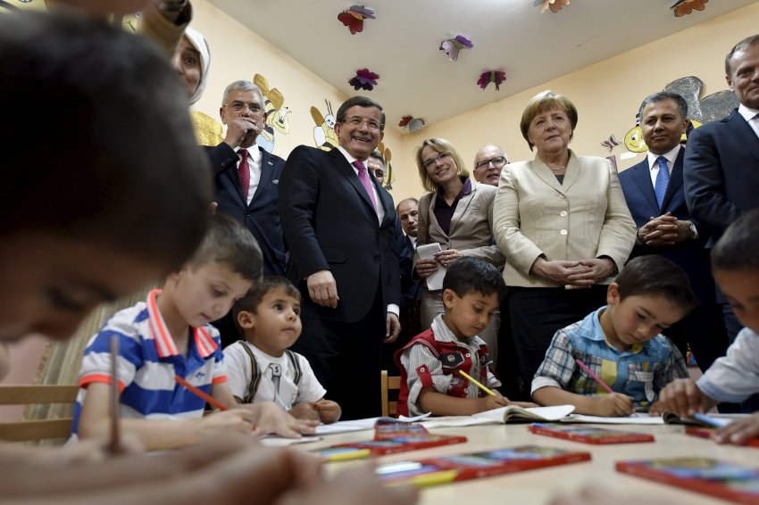 German Chancellor Angela Merkel and Turkish Prime Minister Ahmet Davutoglu visit a group of children in the kindergarten in Nizip refugee camp near Gaziantep, Turkey, April 23, 2016. Bundesregierung/Steffen Kugler/Handout via REUTERS ATTENTION EDITORS - THIS IMAGE WAS PROVIDED BY A THIRD PARTY. EDITORIAL USE ONLY. NO RESALES. NO ARCHIVE.