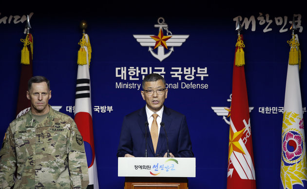 South Korean Defense Ministry's Deputy Minister for Policy Yoo Jeh-seung, center, speaks to the media about deploying the Terminal High-Altitude Area Defense, or THAAD as Lt. Gen. Thomas Vandal, the commander of U.S. Forces Korea's Eighth Army, left, listens during a media briefing at the Defense Ministry in Seoul, South Korea, Friday, July 8, 2016. (AP Photo/Lee Jin-man)