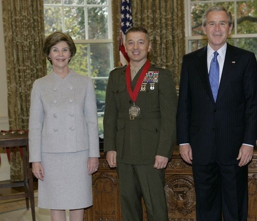P111005ED-0300dh President George W. Bush and Laura Bush stand with 2005 National Humanities Medal recipient U.S. Marine Matthew Bogdanos, also an Assistant District Attorney in New York, Thursday, Nov. 10, 2005 in the Oval Office at the White House. White House photo by Eric Draper