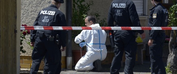 Police are seen investigating a crime scene in Tiefenthal-Leutershausen near Ansbach, southern Germany, after a gunman in a car killed a woman and a cyclist in drive-by shootings on July 10, 2015. The shooter, travelling in a silver Mercedes convertible, also fired at or threatened a farmer and another motorist, before being arrested at a petrol station near the shootings.   AFP PHOTO / THOMAS KIENZLE        (Photo credit should read THOMAS KIENZLE/AFP/Getty Images)