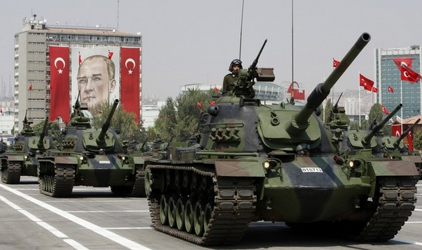 Turkish army tanks roll past a portrait of Mustafa Kemal Ataturk, founder of modern Turkey, during a military parade on the 86th anniversary of Victory Day in Ankara, August 30, 2008. Tensions between Turkey's government and its powerful generals will continue clouding the future of the European Union-applicant country, after the new military commander warned against the rising profile of Islam. REUTERS/Fatih Saribas (TURKEY)