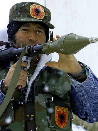 PRI07D:YUGOSLAVIA-KOSOVO:PODUJEVO AREA,SERBIA,28JAN99 - A Kosovo Liberation Army (KLA) guerrilla aims his Rocket Propelled Granade (RPG) as he secures a road at a forest west of Podujevo, some 30 km north of Kosovo's provincial capital Pristina January 28. KLA guerrillas kept their possitions despite a fierce attack by Yugoslav forces on Wednesday. yb/Photo by Yannis Behrakis REUTERS