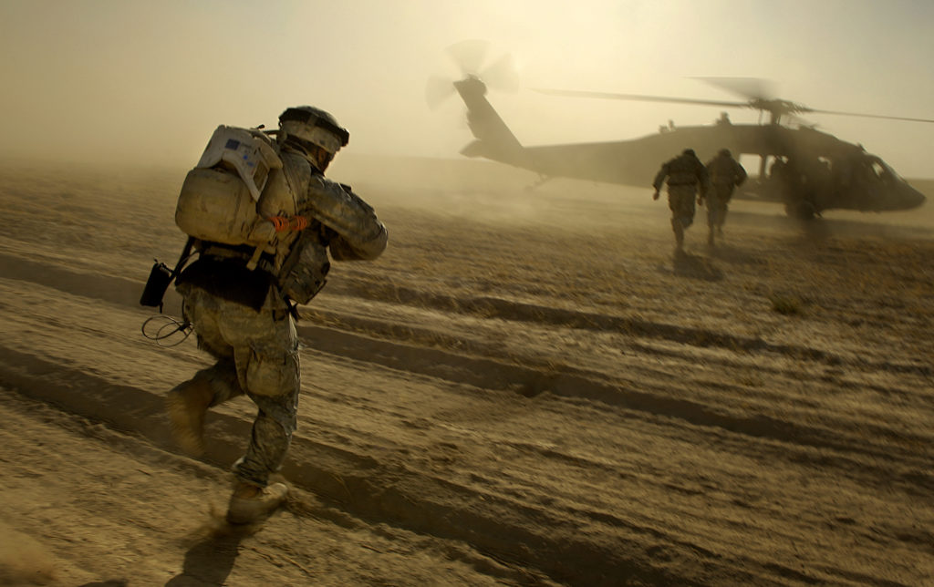 U.S. Army soldiers run towards a UH-60 Black Hawk helicopter as they are extracted after completing an aerial traffic control point mission near Tall Afar, Iraq, on June 5, 2006. The soldiers are from Bravo Company, 4th Battalion, 23rd Infantry Regiment, 172nd Stryker Brigade Combat Team and the Black Hawk aircrew is from Bravo Company, 1st Battalion, 207th Aviation, Alaska National Guard. DoD photo by Staff Sgt. Jacob N. Bailey, U.S. Air Force. (Released)