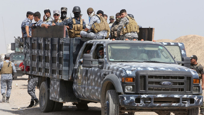 Iraqi security forces and paramilitaries deploy, on May 26, 2015, in al-Nibaie area, north-west of Baghdad, during an operation aimed at cutting off Islamic State (IS) jihadists in Anbar province before a major offensive to retake the city of Ramadi. Iraqi forces closed in on Ramadi and launched the operation dubbed Labaik ya Hussein", which roughly translates as "We are at your service, Hussein" and refers to one of the most revered imams in Shiite Islam. It will see a mix of security forces and paramilitaries move south towards the city from Salaheddin province, said Hashed al-Shaabi ("popular mobilisation" in Arabic) spokesman Ahmed al-Assadi. AFP PHOTO/AHMAD AL-RUBAYEAHMAD AL-RUBAYE/AFP/Getty Images