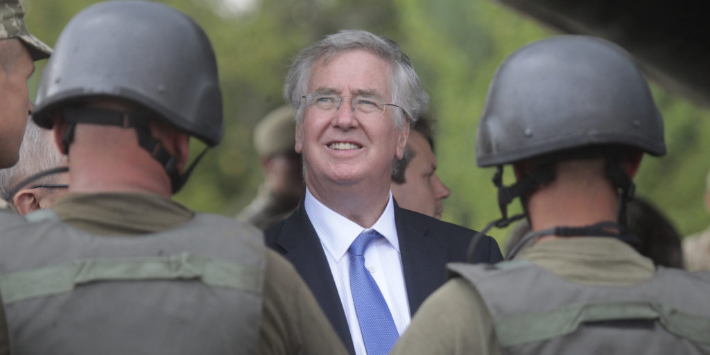 British Secretary of State for Defense, Michael Fallon, speaks with Ukrainian soldiers on the military base outside Zhitomir, Ukraine, Tuesday, Aug. 11, 2015. Britain's defense secretary says his nation is doubling the number of Ukrainian troops it will train this year in an effort to support Kiev in its fight against Russia-backed separatists. (AP Photo / Efrem lukatsky)