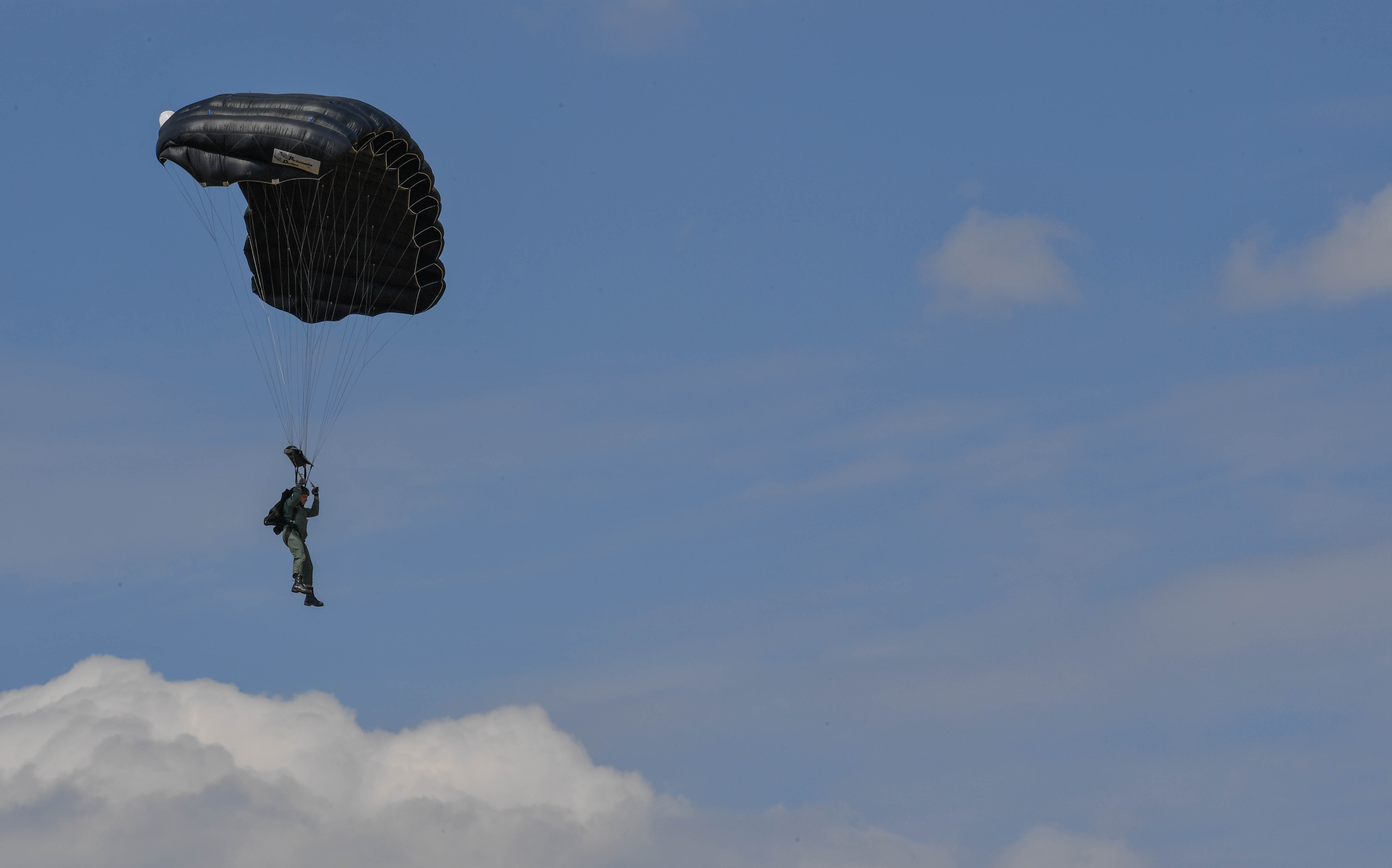 A Greek paratrooper descends to the ground after conducting a military free fall jump from a U.S. Air Force C-130J Super Hercules during Exercise Stolen Cerberus IV above Megara, Greece, April 22, 2017. The U.S. Air Force and Army have worked alongside the Hellenic air force to perform personnel and cargo drops throughout the exercise. These interoperability air exercises help to maintain joint readiness. (U.S Air Force photo by Senior Airman Tryphena Mayhugh)